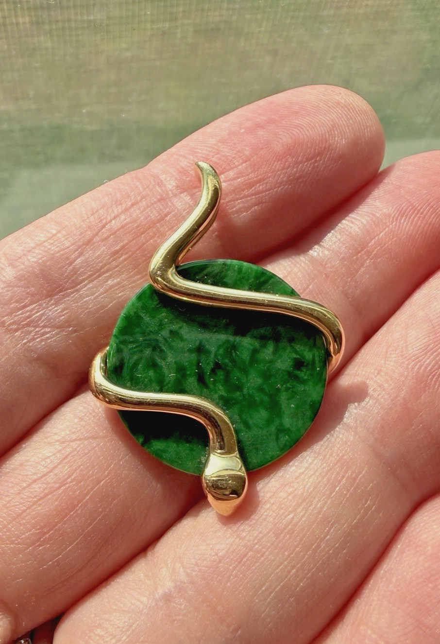 Natural Type A jadeite pendant with an 18K gold serpent wrap – from Kathy Jade