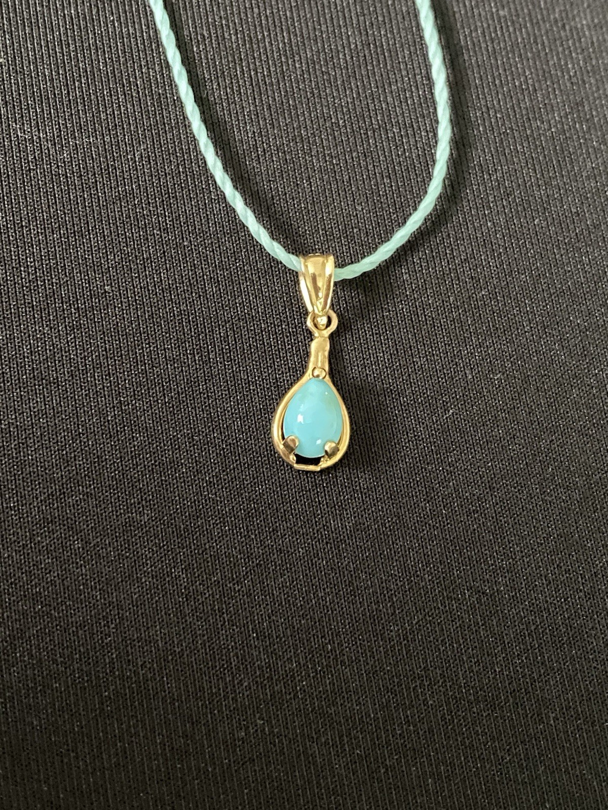 Beautiful Turquoise Pendant Set In 14K Yellow Gold On A Blue Cord