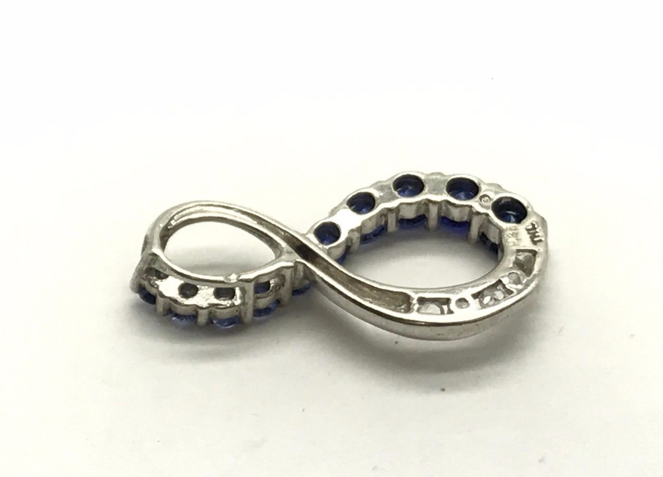 Sterling Silver Channel Set Descending Blue Tanzanite CZ Infinity Swirl Pendant