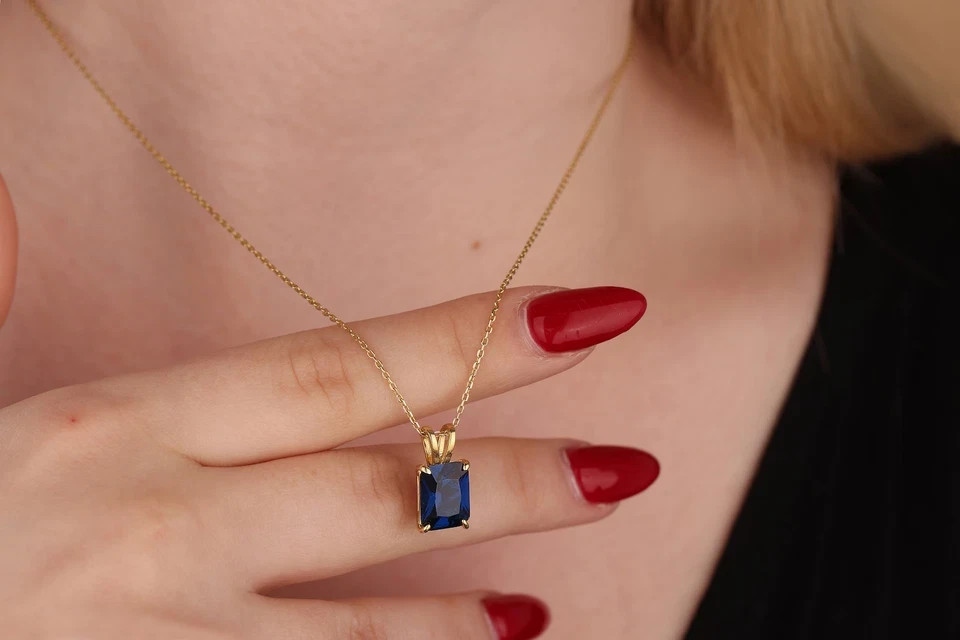 2 Ct Emerald Cut Lab Created Sapphire Women’s Pendant 14K Yellow Gold Plated