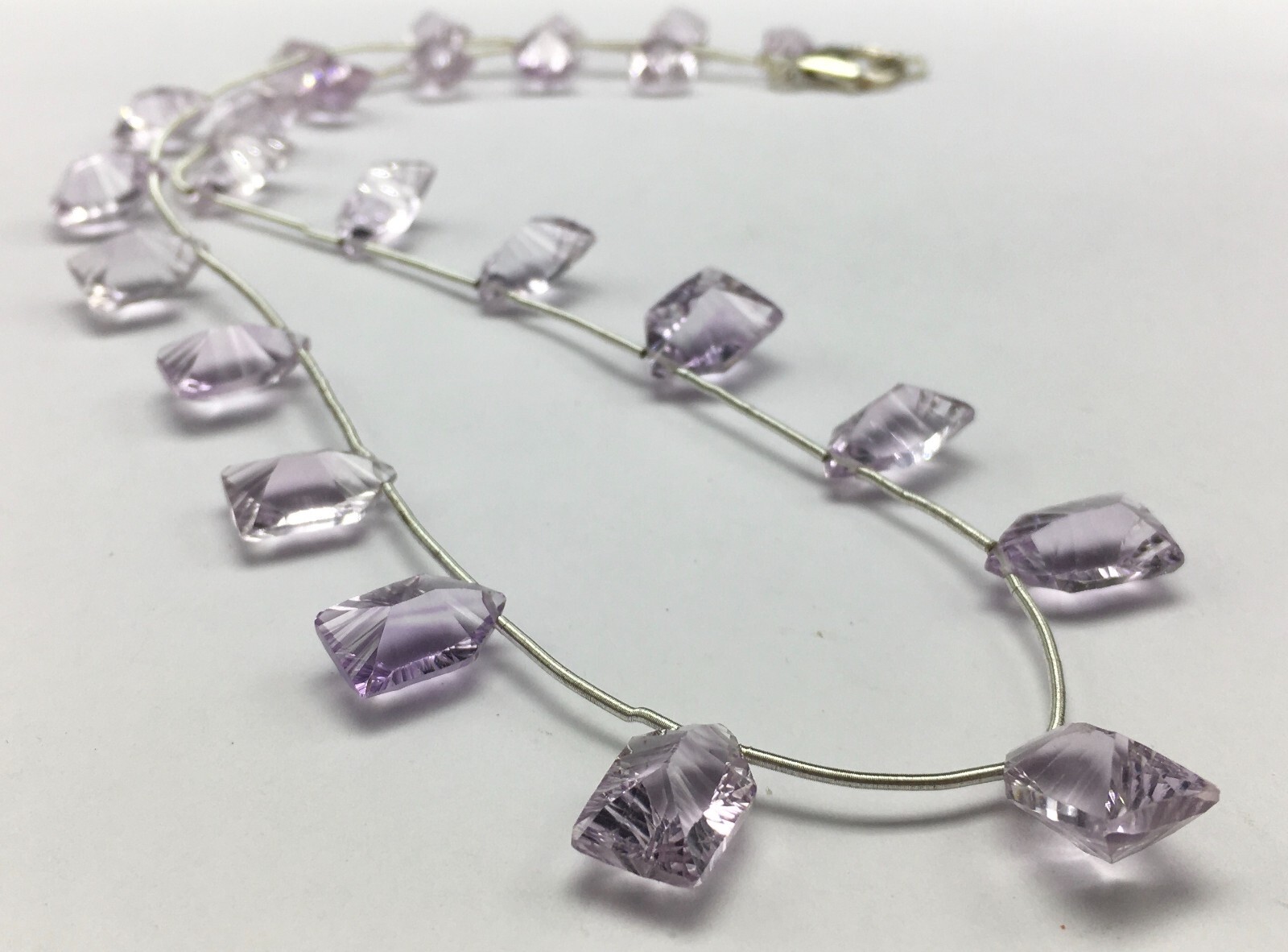 Natural LIGHT AMETHYST/Fancy/Concave/7x11M till 8x14MM/105.60 Cts/19″/$ 301.00