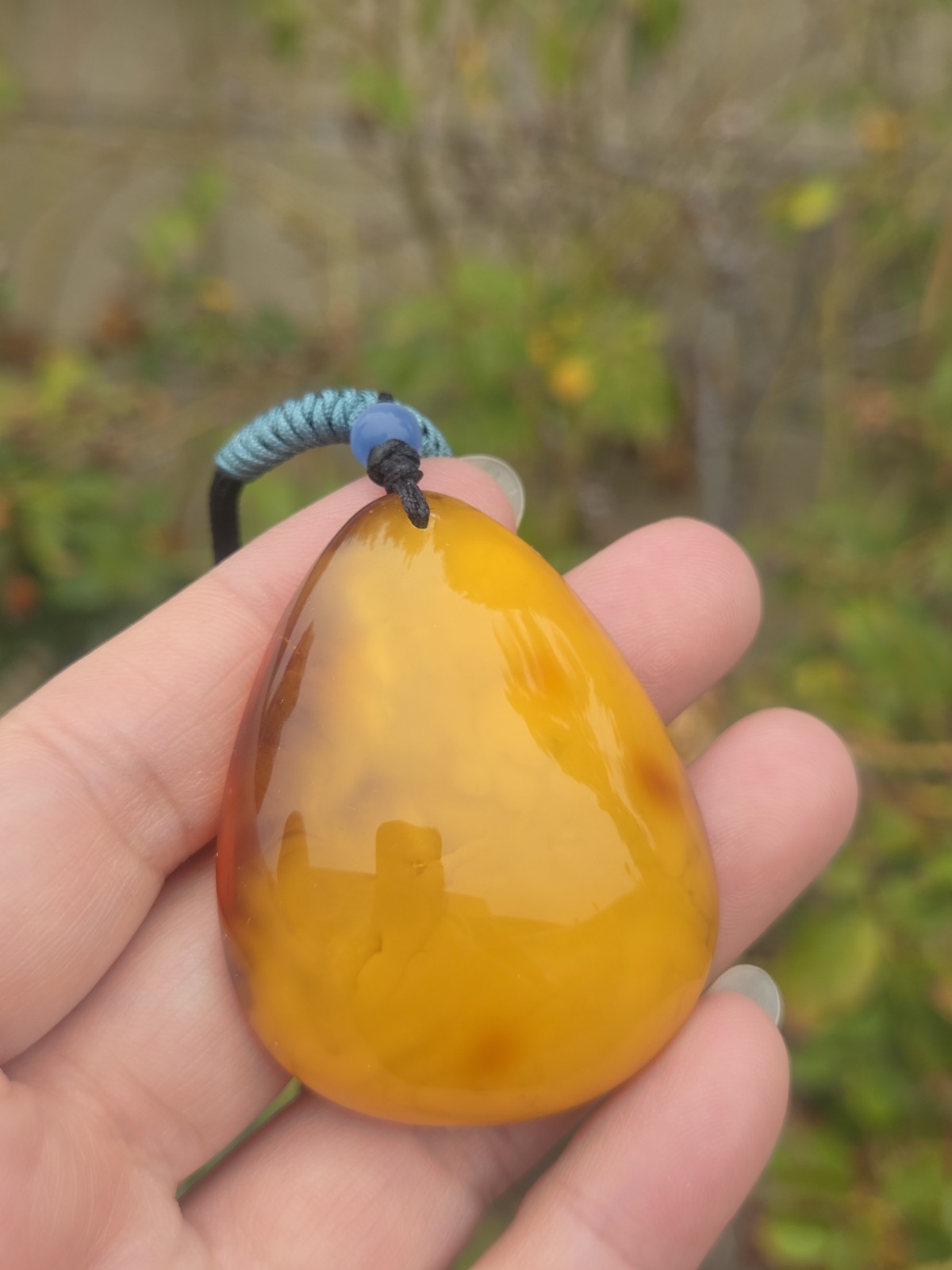 Rich Egg Yolk Amber Teardrop Pendant with Natural Red Skin