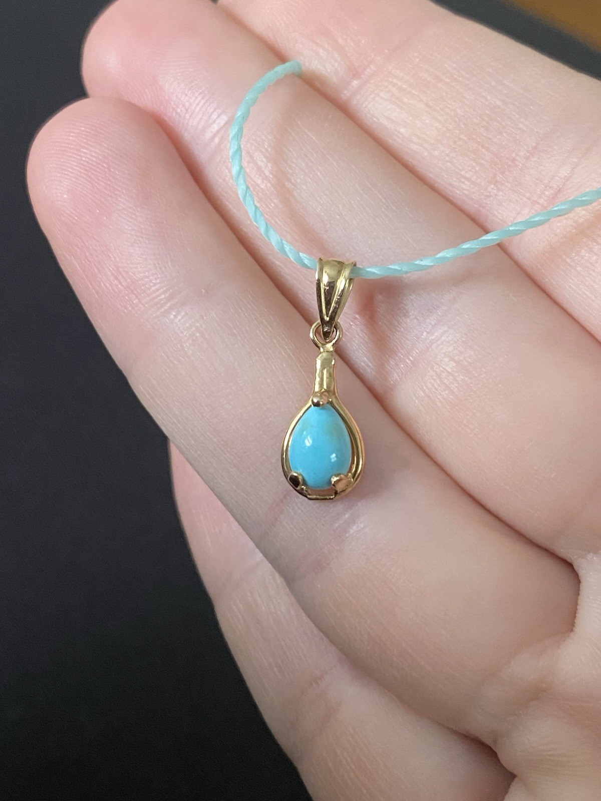 Beautiful Turquoise Pendant Set In 14K Yellow Gold On A Blue Cord