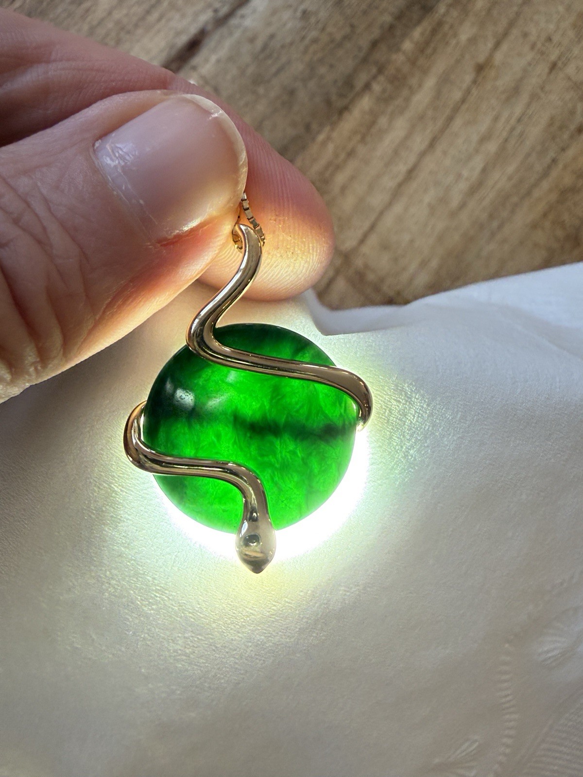Natural Type A jadeite pendant with an 18K gold serpent wrap – from Kathy Jade