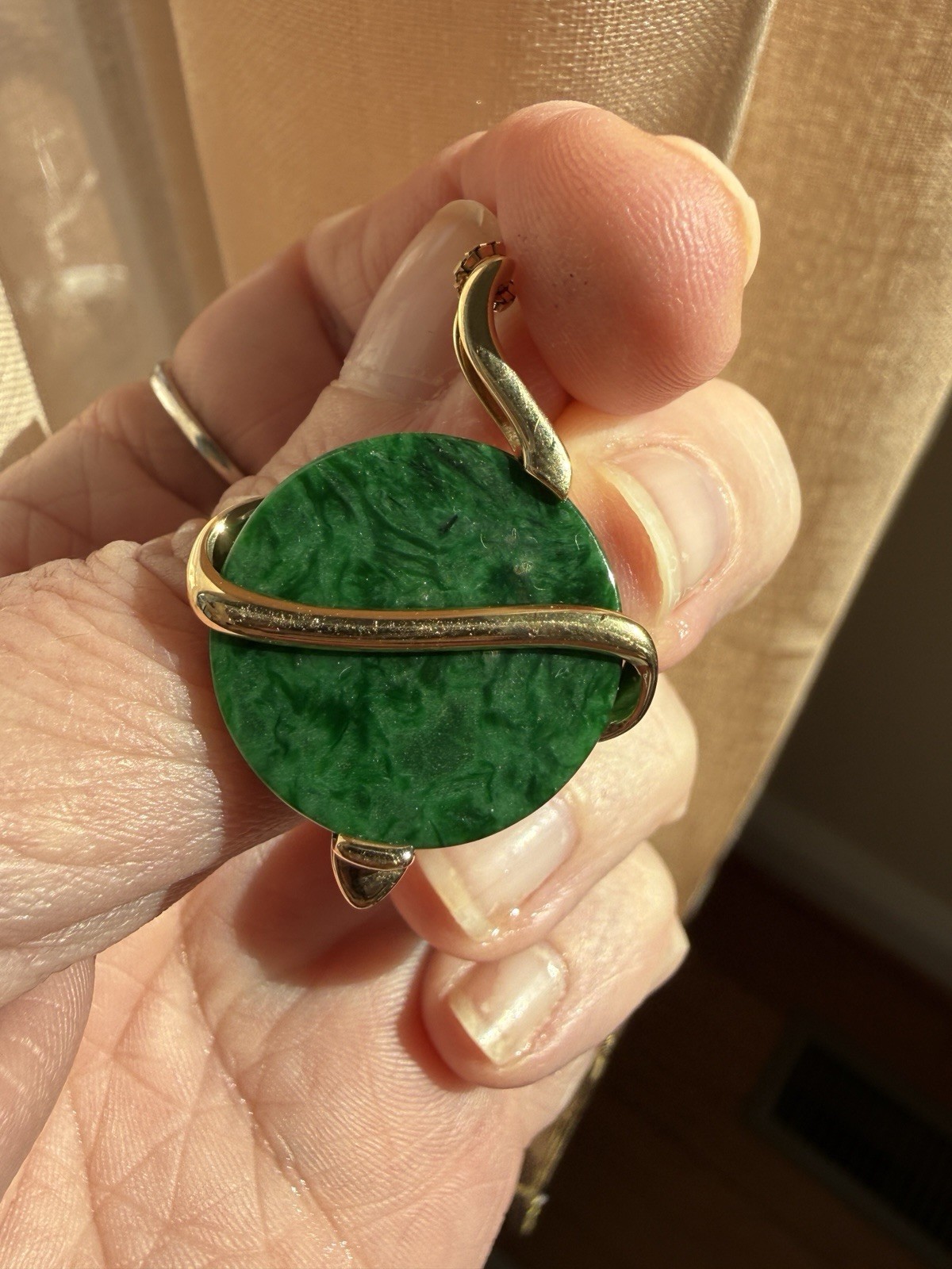 Natural Type A jadeite pendant with an 18K gold serpent wrap – from Kathy Jade