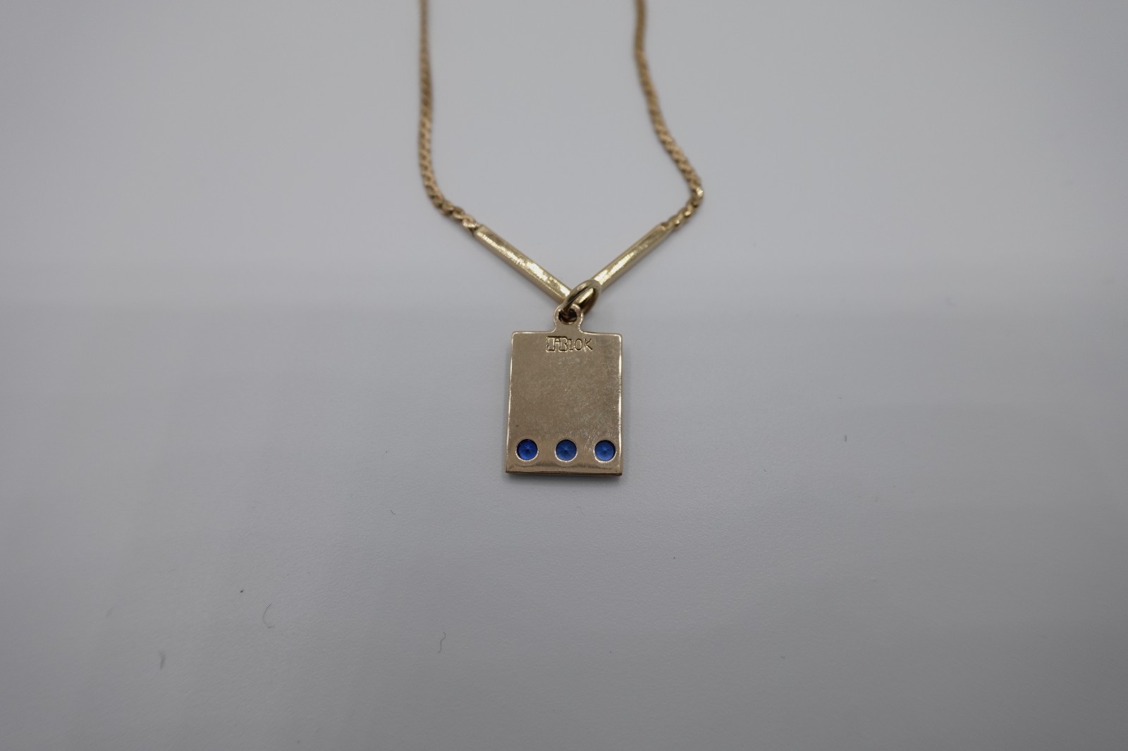 10k stamped gold pendant with unknown stones clasp on chain is stamped 1/2012