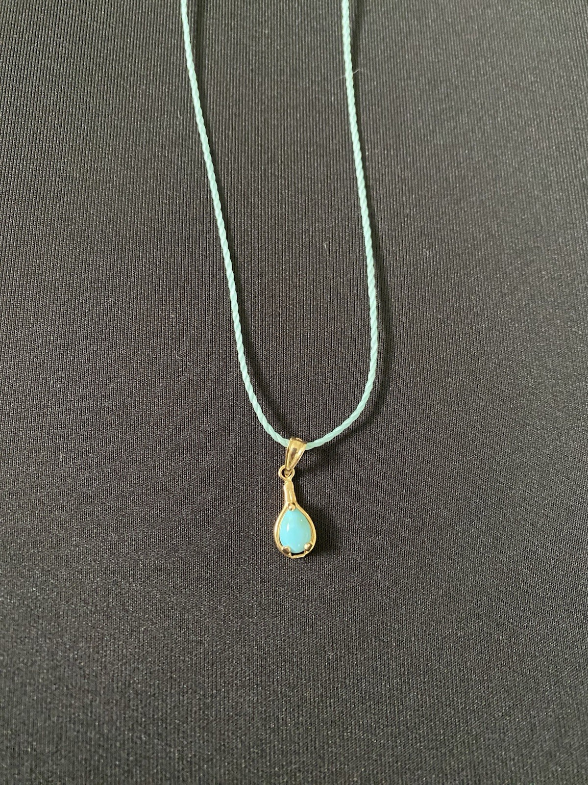 Beautiful Turquoise Pendant Set In 14K Yellow Gold On A Blue Cord