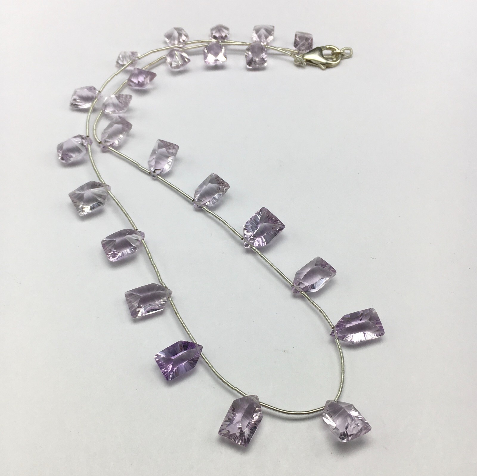 Natural LIGHT AMETHYST/Fancy/Concave/7x11M till 8x14MM/105.60 Cts/19″/$ 301.00
