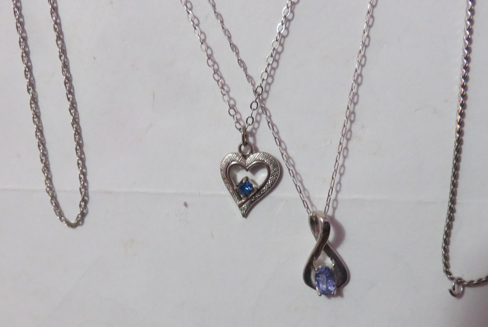 4 MARKED “STERLING” SILVER & ONE BGE CHAIN NECKLACES & 3 PENDANTS 8 GRAMS