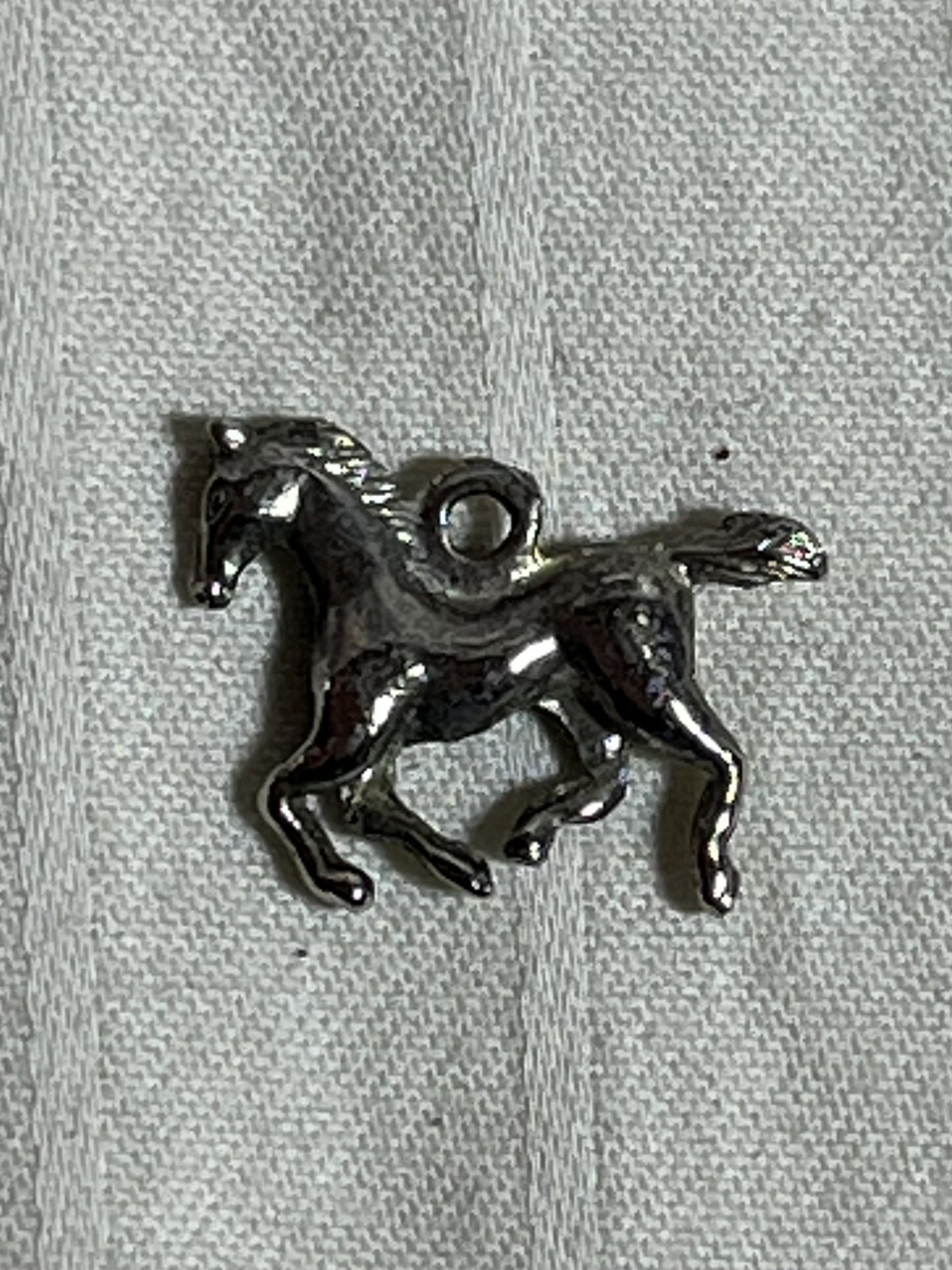 Silver toned necklace charm. Running Horse. Foal. 1 inch. Very Good Condition