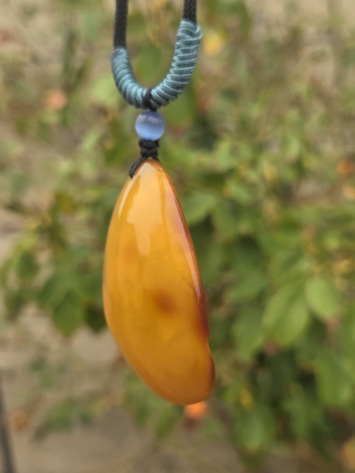 Rich Egg Yolk Amber Teardrop Pendant with Natural Red Skin