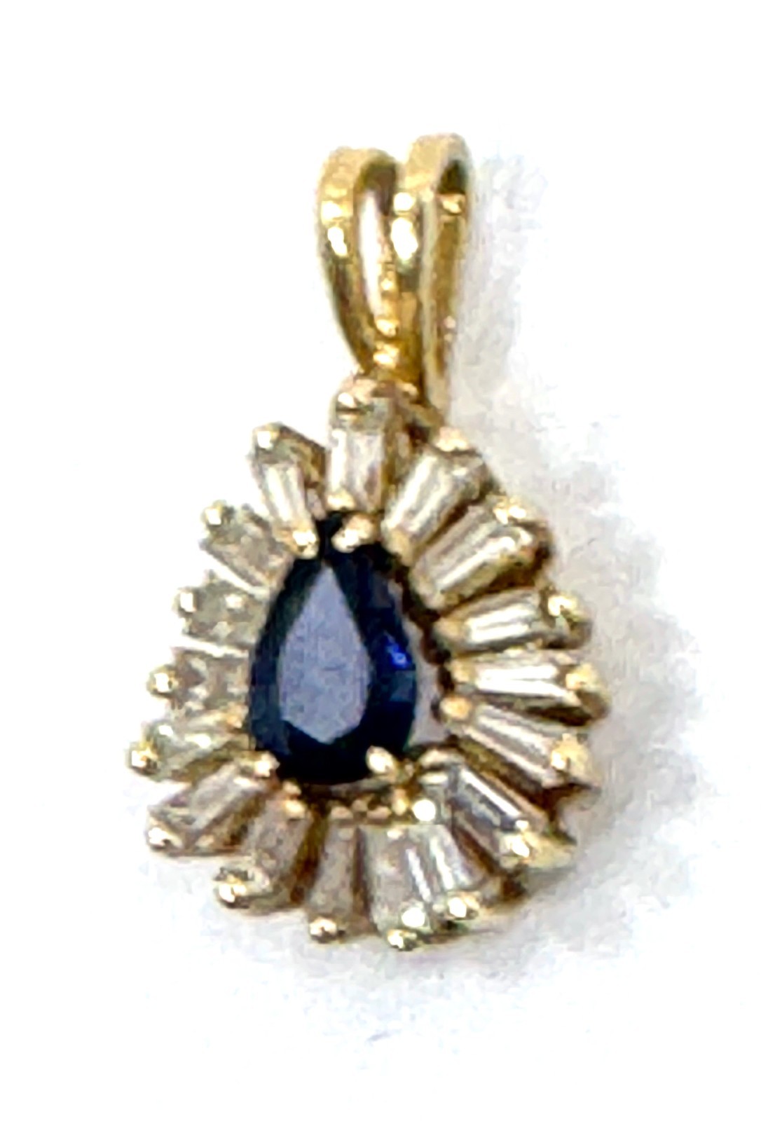 14k gold pear-shape sapphire with a halo of baguette-cut diamond pendant