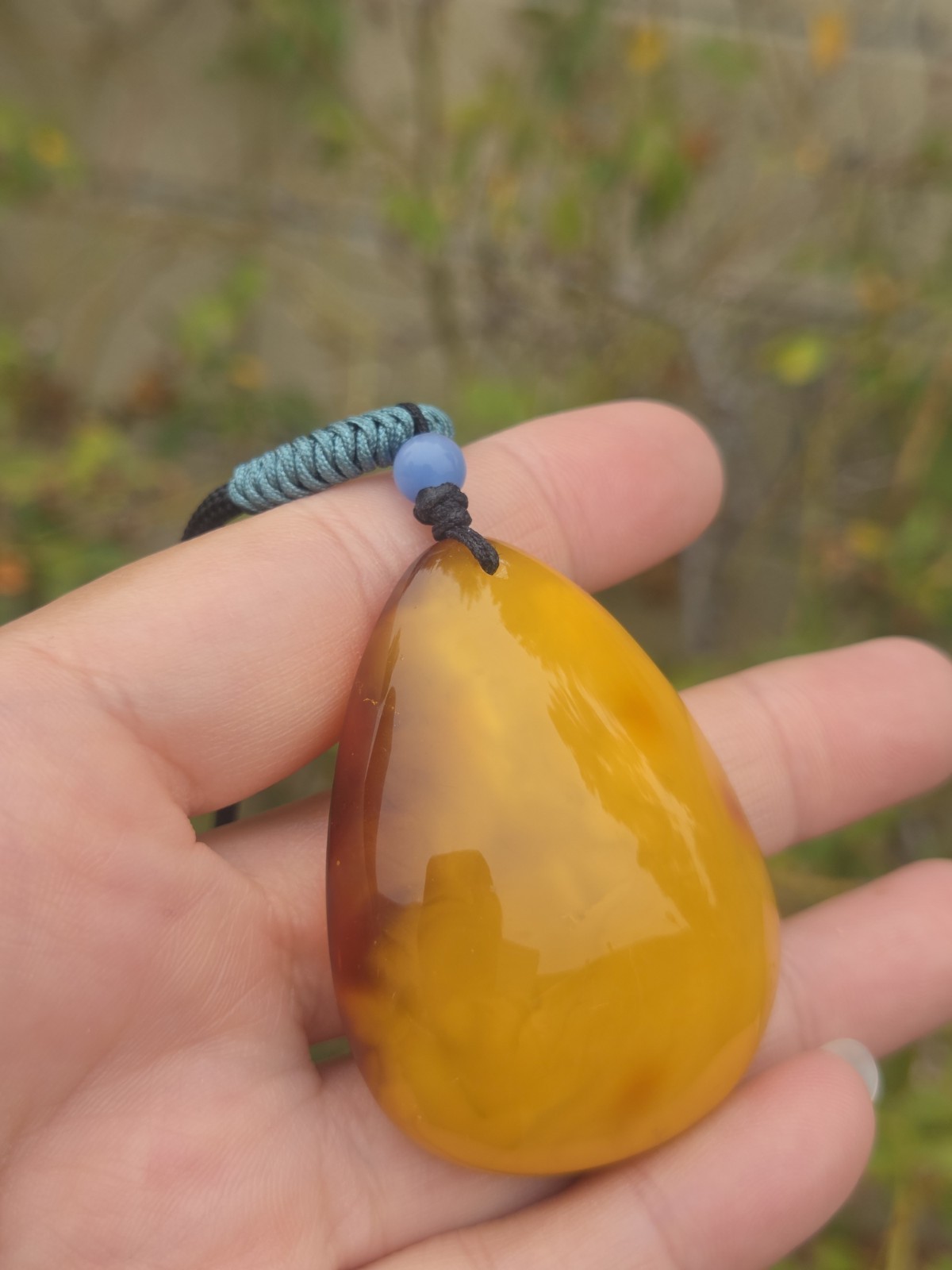 Rich Egg Yolk Amber Teardrop Pendant with Natural Red Skin