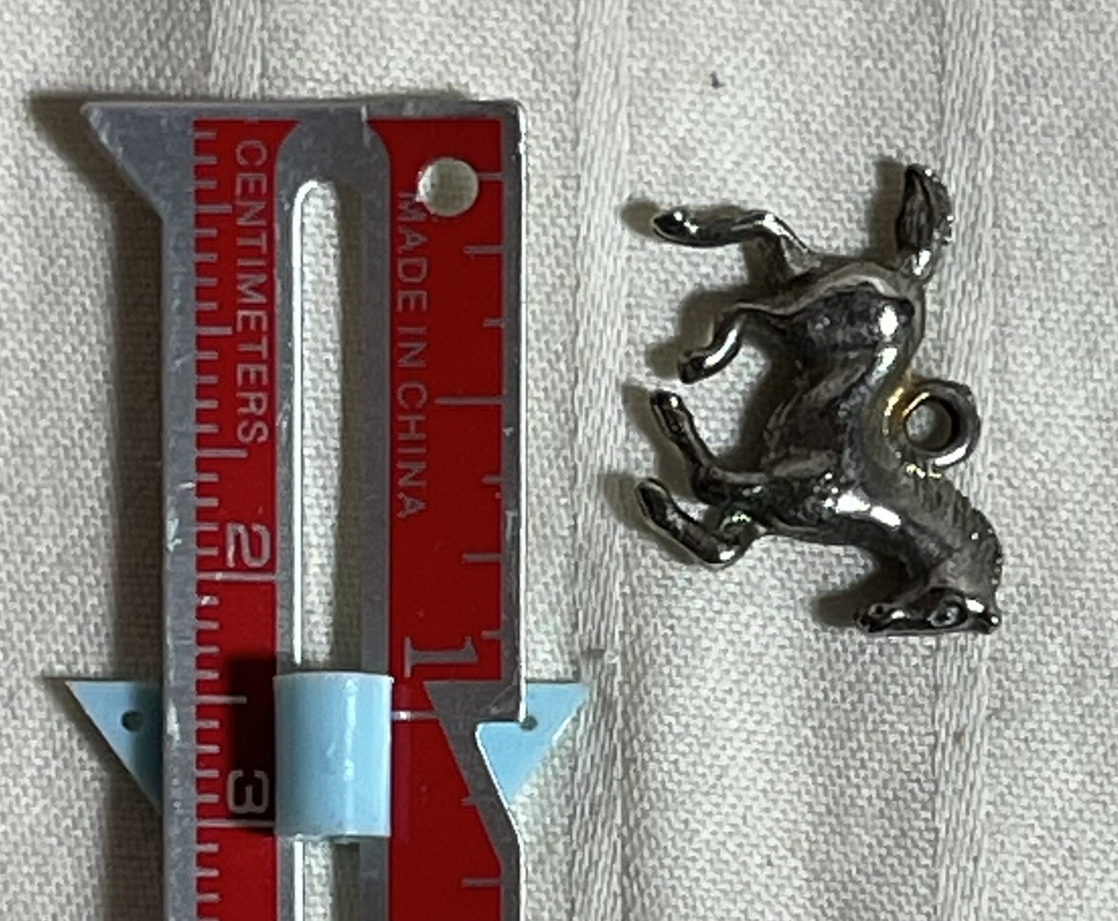Silver toned necklace charm. Running Horse. Foal. 1 inch. Very Good Condition