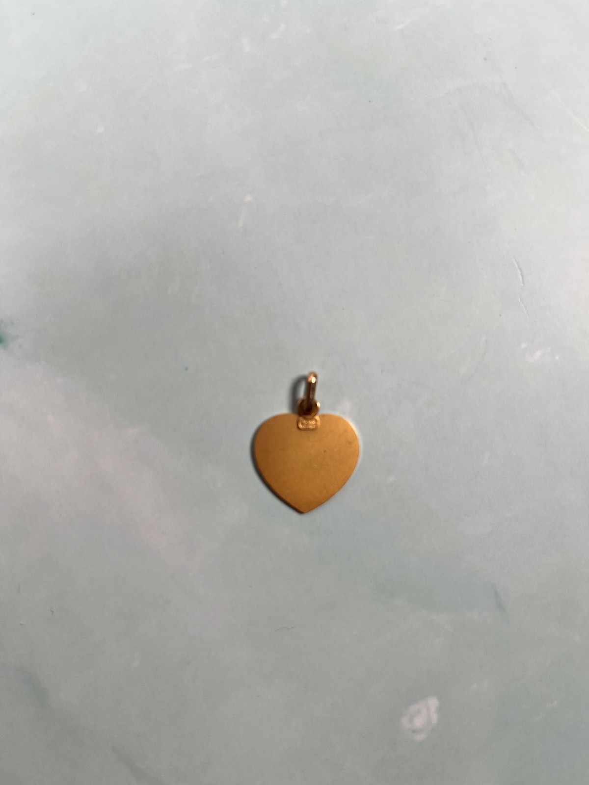18k solid Gold angel child heart pedant. grams in weight.