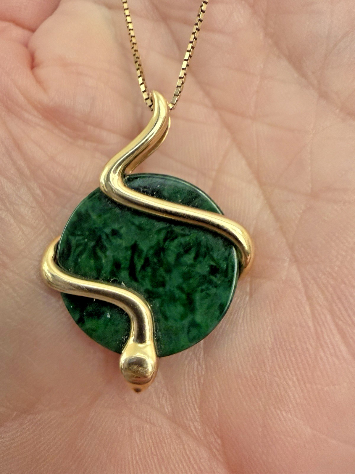 Natural Type A jadeite pendant with an 18K gold serpent wrap – from Kathy Jade