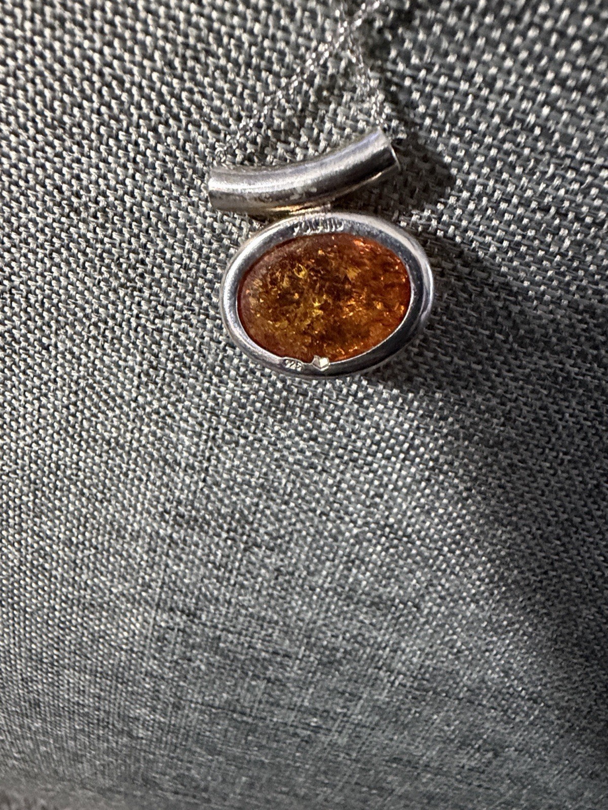 vintage-style oval Baltic amber pendant is set in .925 sterling silver with a di