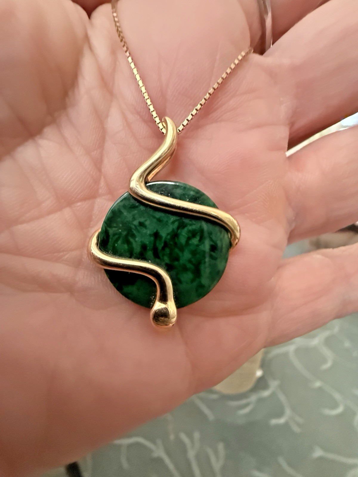 Natural Type A jadeite pendant with an 18K gold serpent wrap – from Kathy Jade
