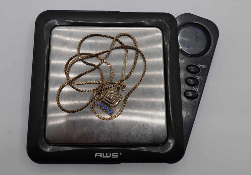 10k stamped gold pendant with unknown stones clasp on chain is stamped 1/2012