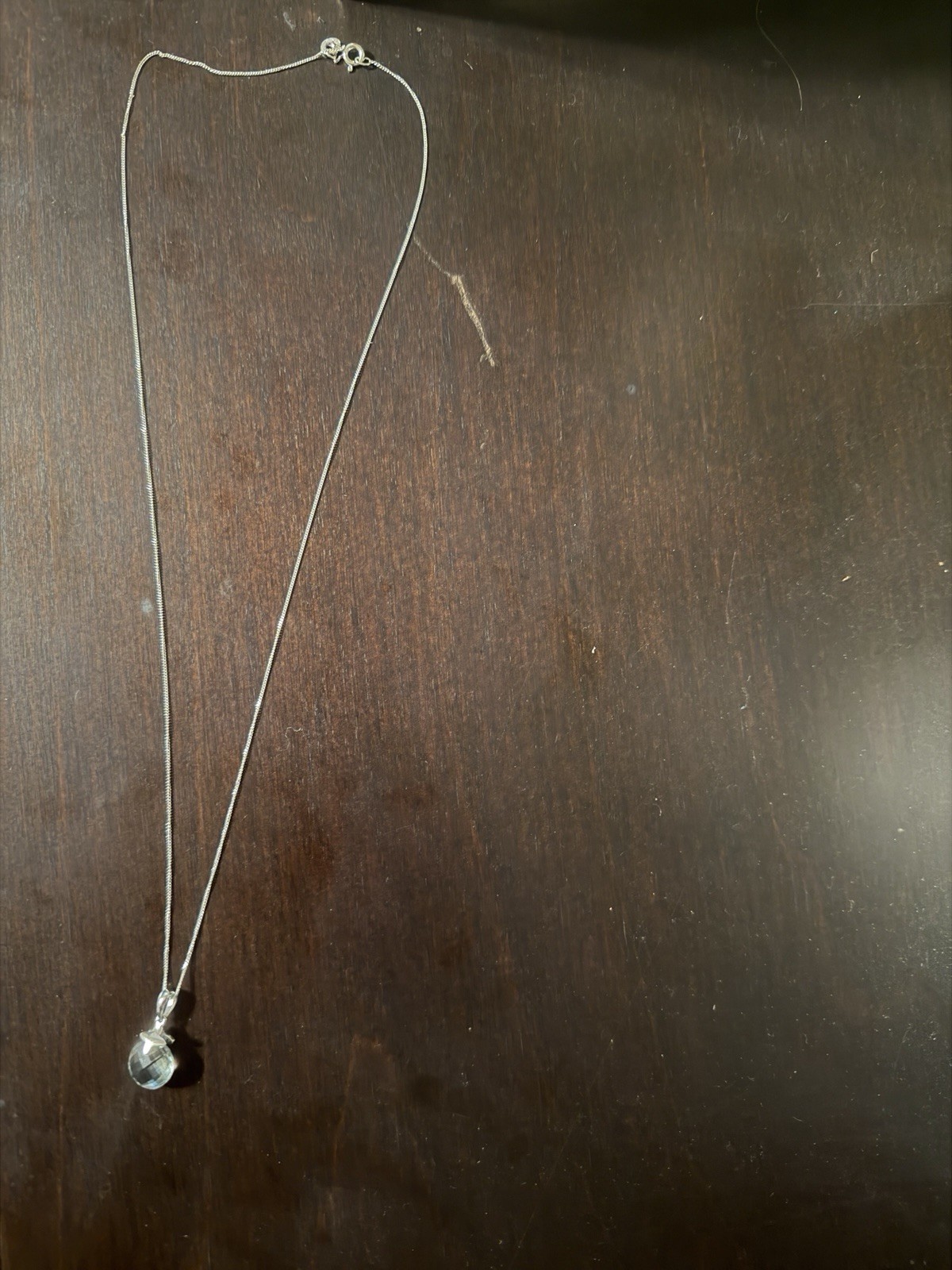 Sterling Silver and Green Amethyst pendant on a chain.