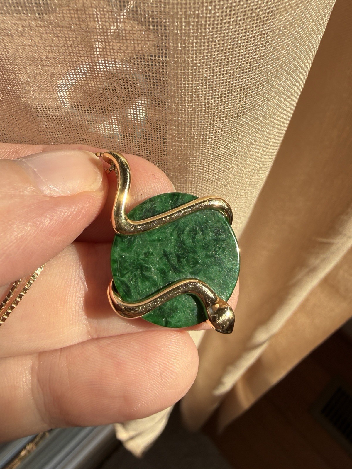 Natural Type A jadeite pendant with an 18K gold serpent wrap – from Kathy Jade