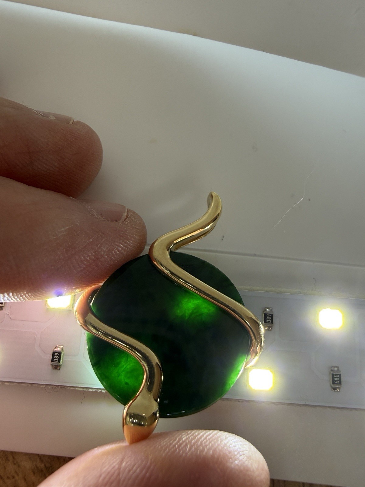 Natural Type A jadeite pendant with an 18K gold serpent wrap – from Kathy Jade