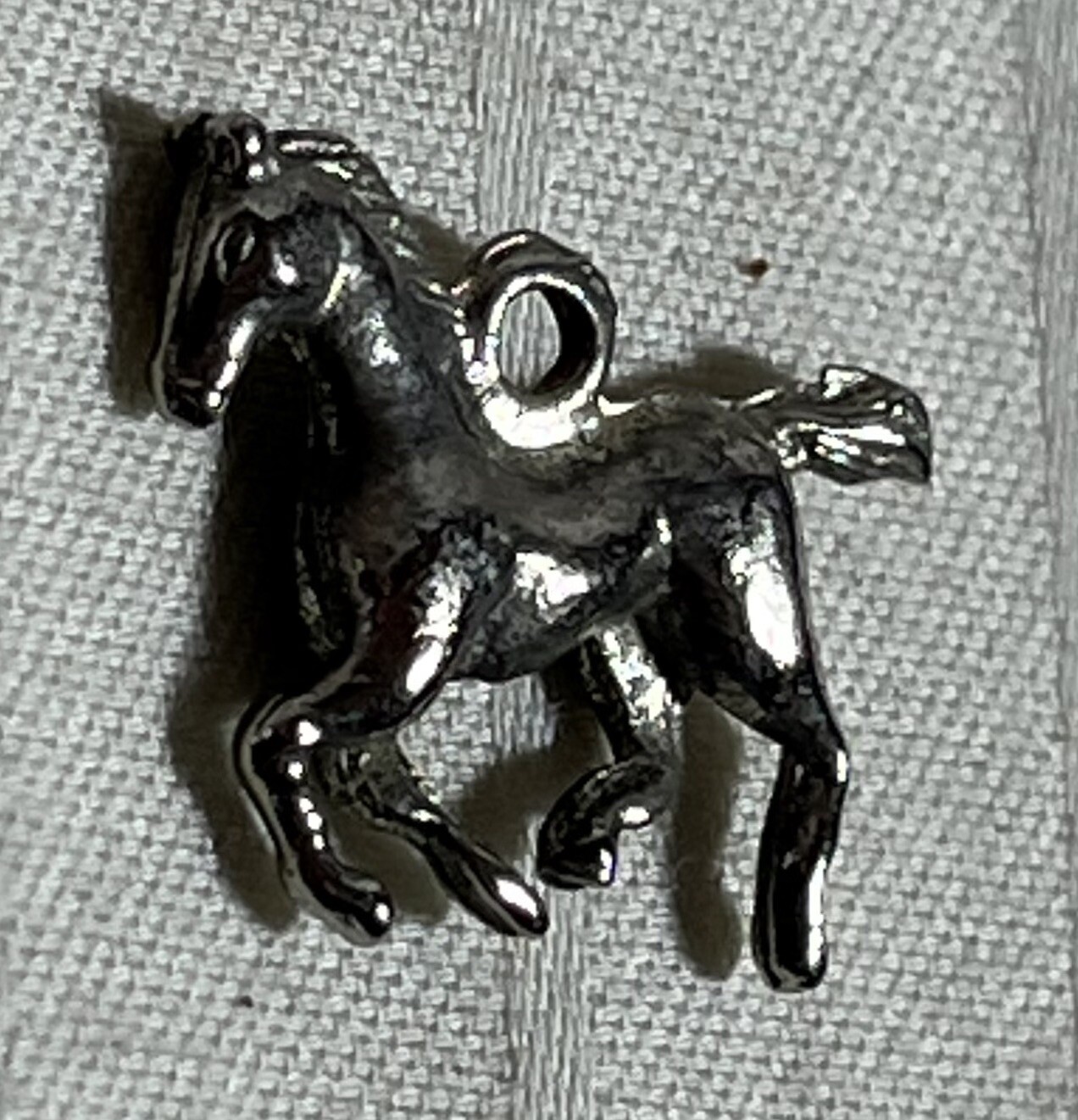 Silver toned necklace charm. Running Horse. Foal. 1 inch. Very Good Condition