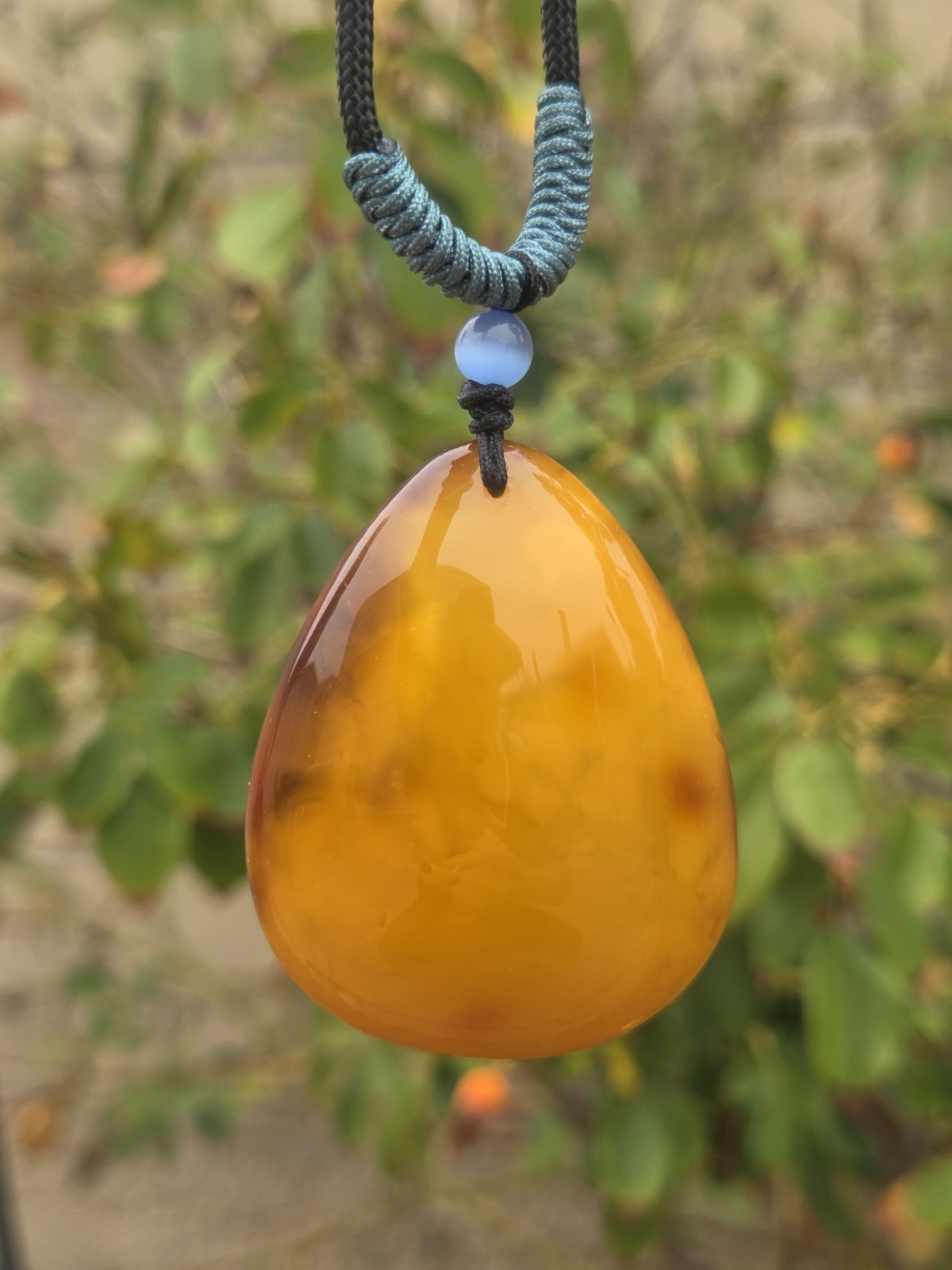 Rich Egg Yolk Amber Teardrop Pendant with Natural Red Skin
