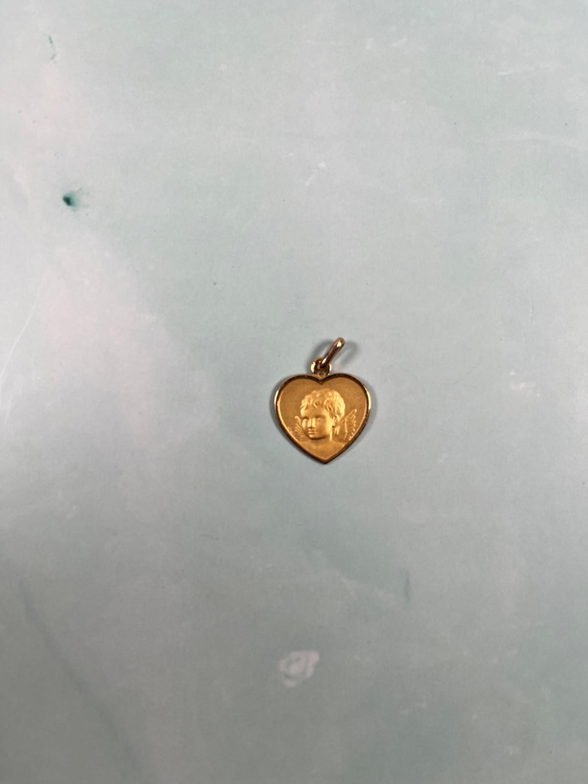 18k solid Gold angel child heart pedant. grams in weight.