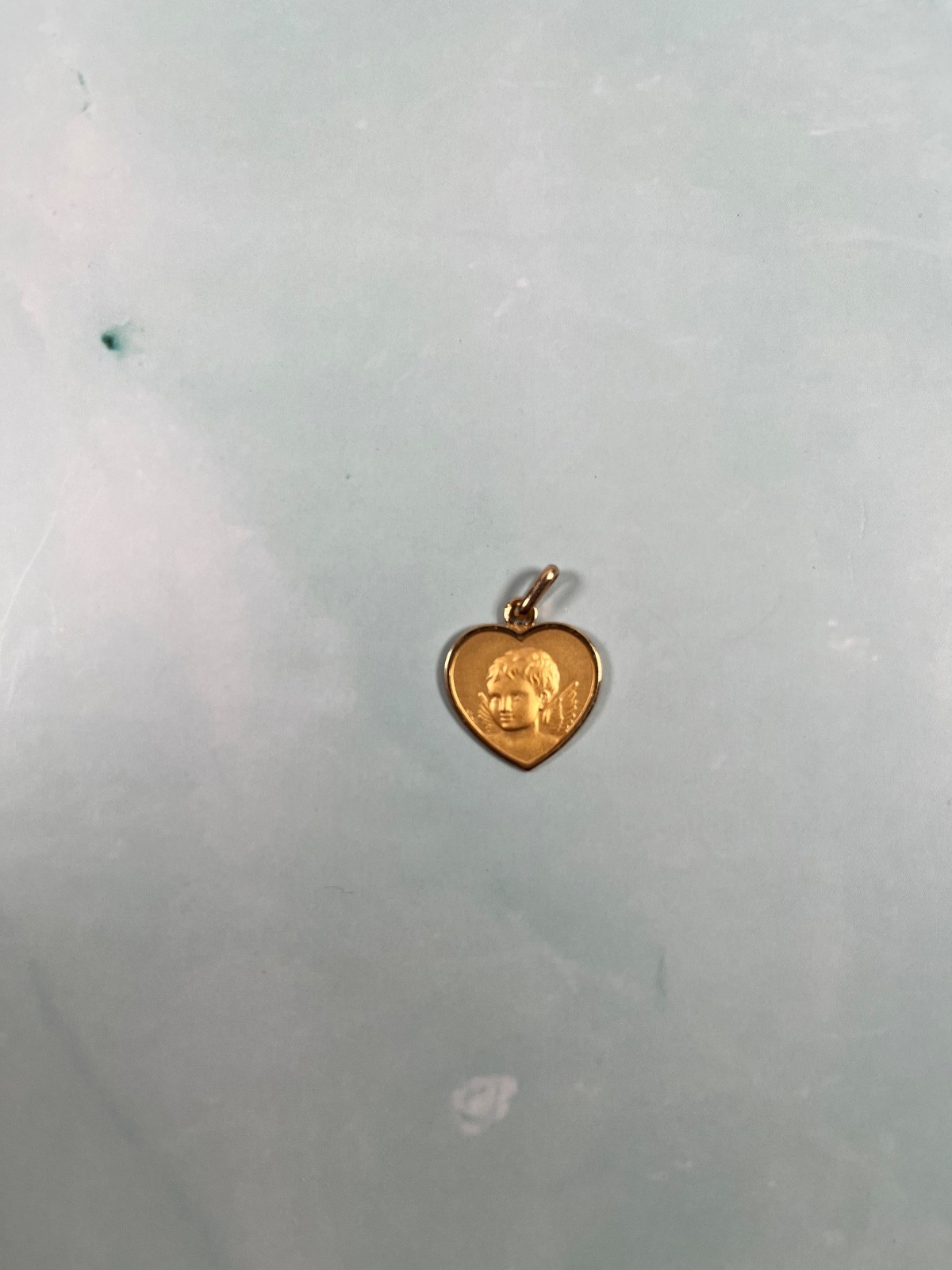 18k solid Gold angel child heart pedant. grams in weight.