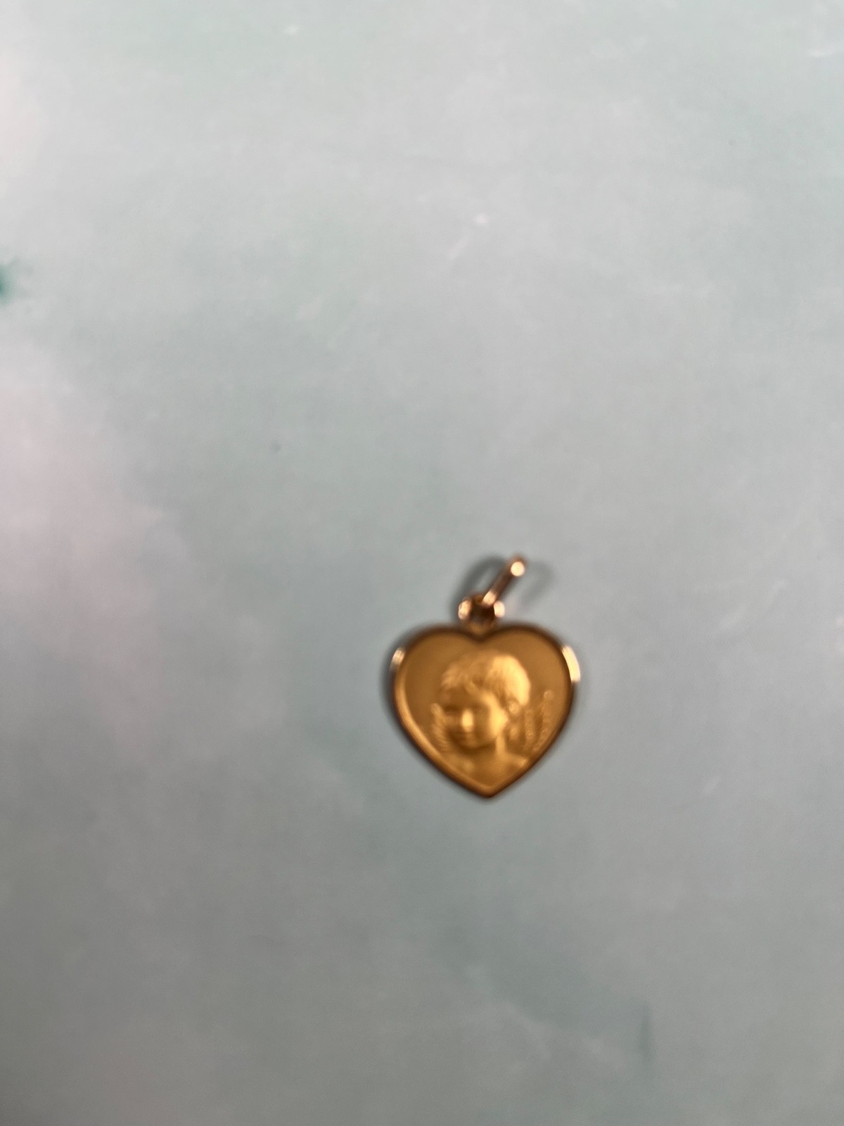 18k solid Gold angel child heart pedant. grams in weight.