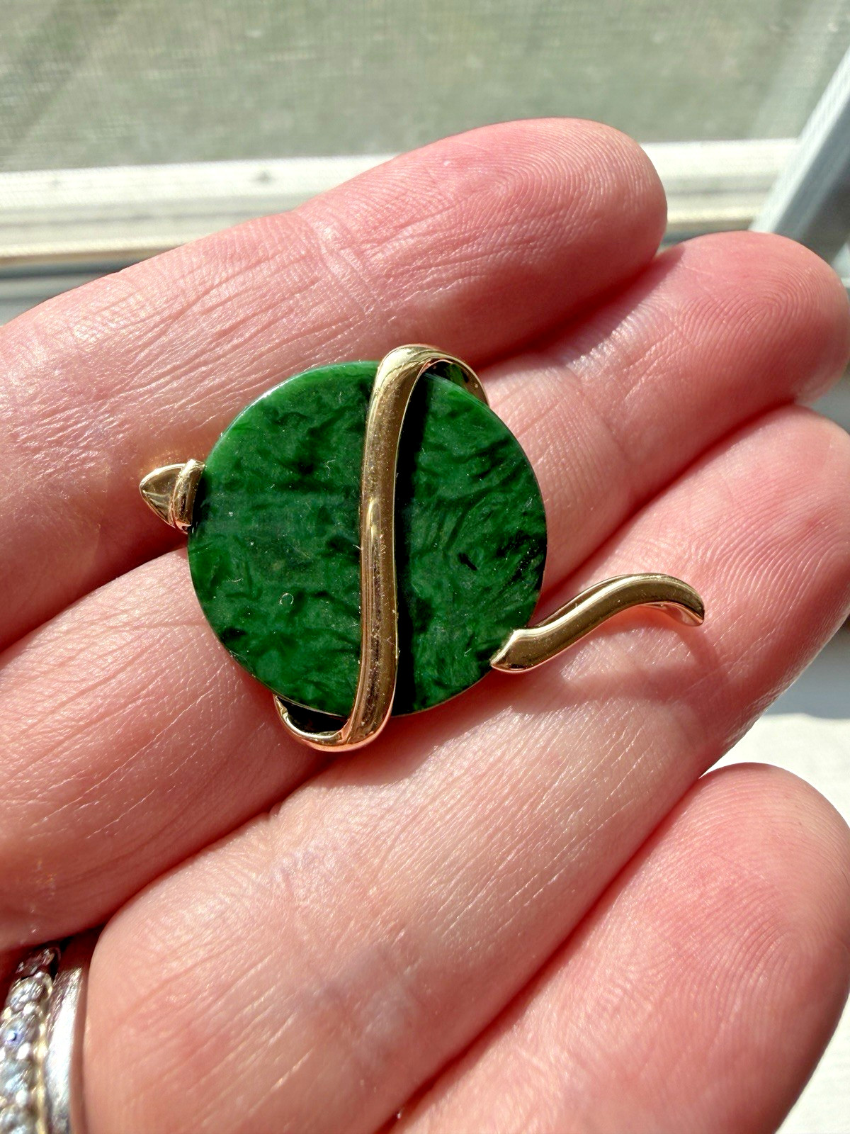 Natural Type A jadeite pendant with an 18K gold serpent wrap – from Kathy Jade