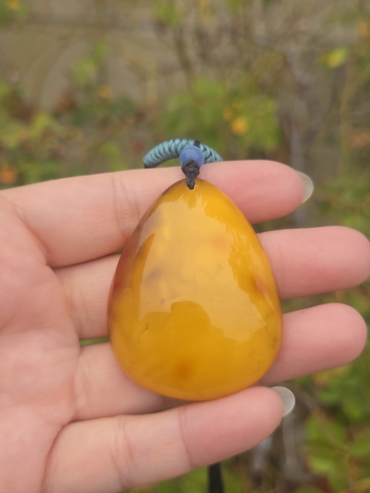 Rich Egg Yolk Amber Teardrop Pendant with Natural Red Skin