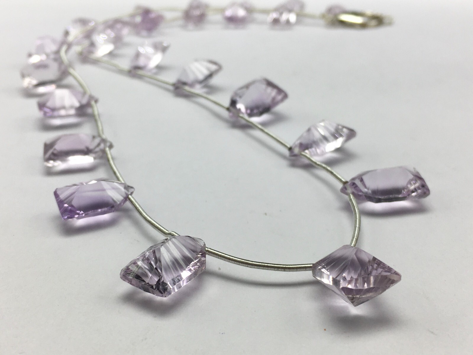 Natural LIGHT AMETHYST/Fancy/Concave/7x11M till 8x14MM/105.60 Cts/19″/$ 301.00