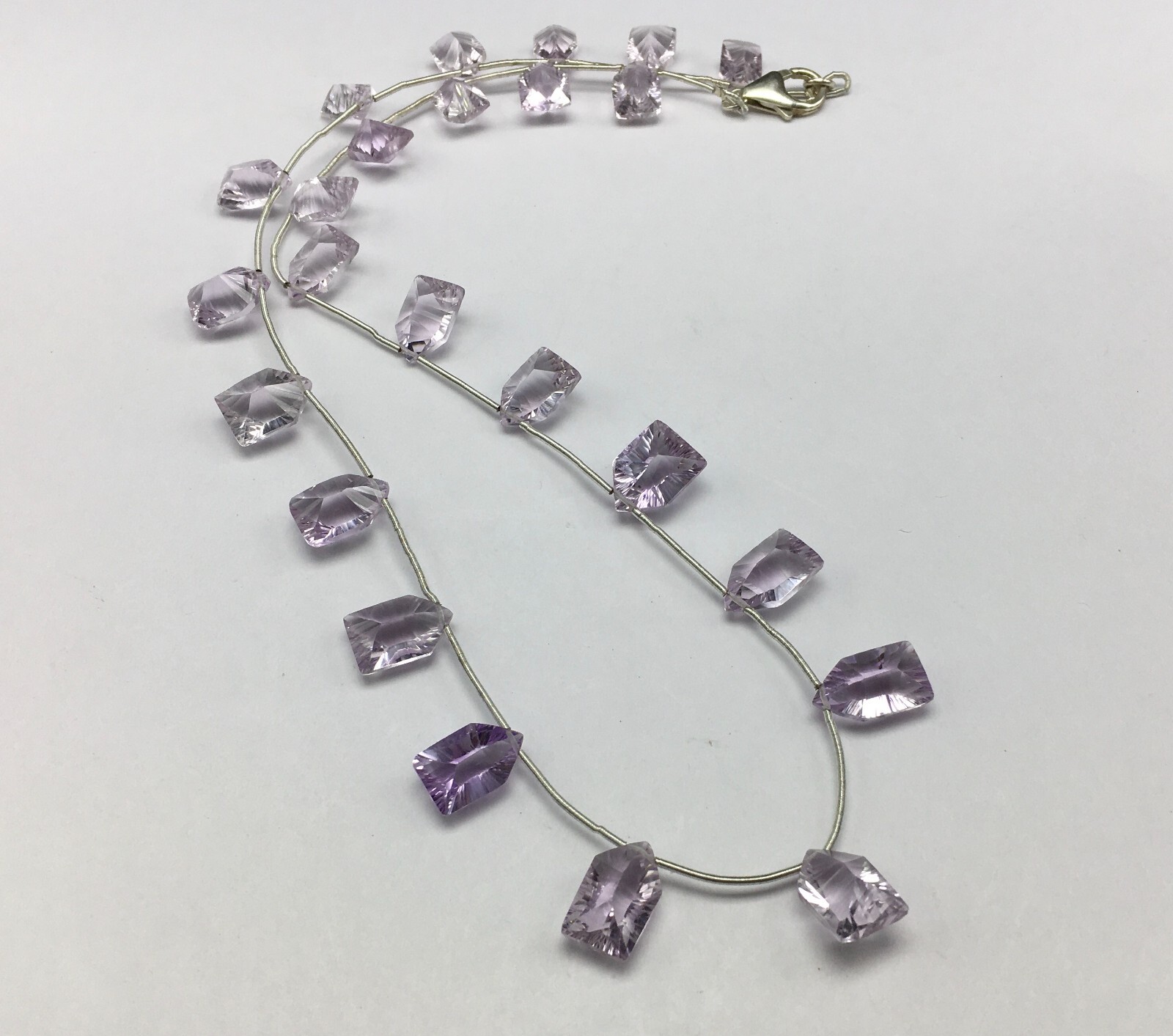 Natural LIGHT AMETHYST/Fancy/Concave/7x11M till 8x14MM/105.60 Cts/19″/$ 301.00