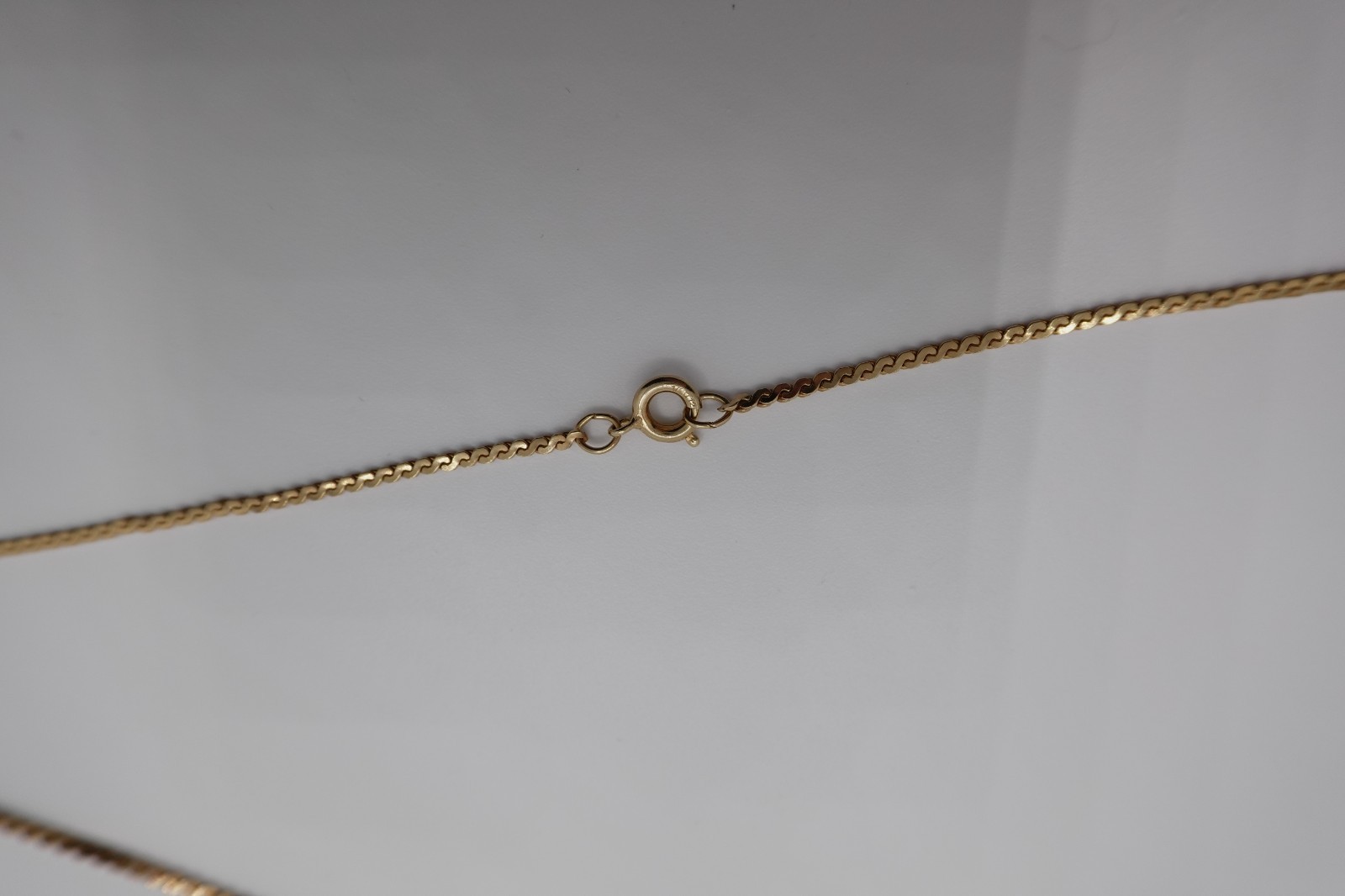10k stamped gold pendant with unknown stones clasp on chain is stamped 1/2012