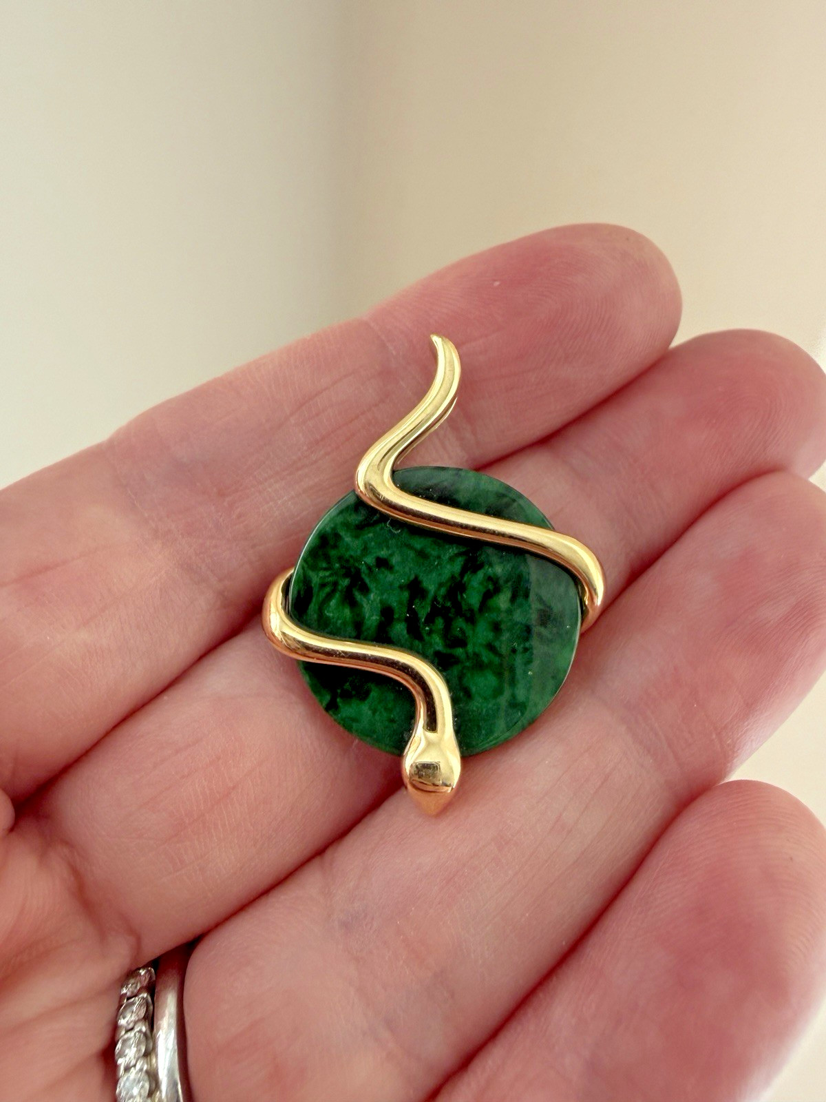 Natural Type A jadeite pendant with an 18K gold serpent wrap – from Kathy Jade