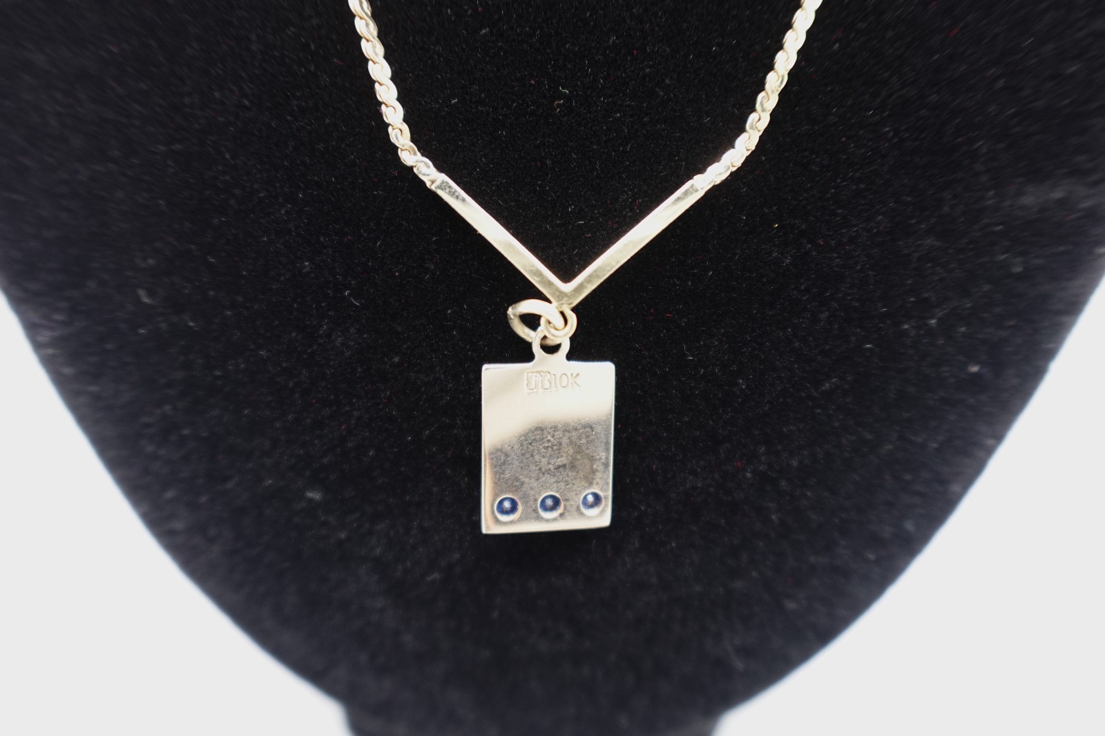 10k stamped gold pendant with unknown stones clasp on chain is stamped 1/2012